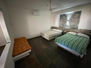 a room with two beds and a bench in it at Costa Ayala - Bungalow 1 with 2 dbl beds and 2 sofas in Los Ayala +7 photos