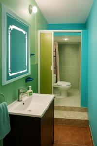 a bathroom with a sink and a toilet at Ethlyn House in Bocas Town +53 photos