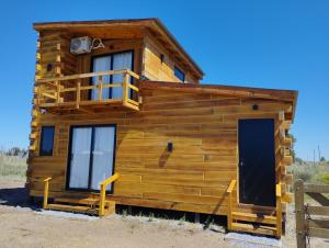 a log cabin with a balcony and a door at Casas de Mar Cielo Azul in Balneario Reta