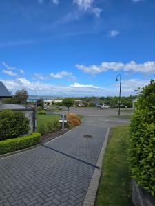 a cobblestone walkway in a park with a street light at Enjoy 4br home with lots of comfort & convenience in Taupo