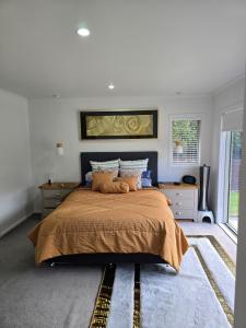 a bedroom with a large bed and a window at Enjoy 4br home with lots of comfort & convenience in Taupo