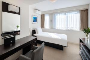 Postel nebo postele na pokoji v ubytování Oakwood Residence Aoyama Tokyo