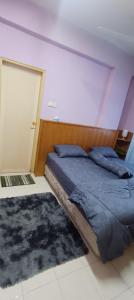 Postel nebo postele na pokoji v ubytování KT Harmoni Homestay