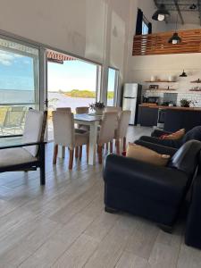a living room with a table and chairs and a kitchen at La moradaa in Federación