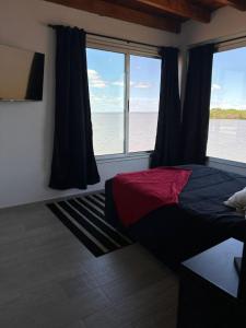 a bedroom with a bed with a view of the ocean at La moradaa in Federación +11 photos