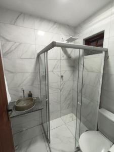 a bathroom with a shower with a sink and a toilet at Hotel Pousada Velas ao Mar in Maceió
