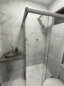 a bathroom with a shower with a toilet and a sink at Hotel Pousada Velas ao Mar in Maceió