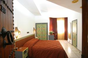 A bed or beds in a room at Hotel Chellah