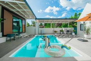 a swimming pool in the middle of a house at Lamoon Village Khaoyai บ้านละมุน เขาใหญ่ in Pak Chong