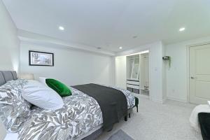 a bedroom with a bed with green pillows at SPACIOUS FULLY PRIVATE 2BR UNIT ON GROUND Private 2BR LEVEL in Burlington