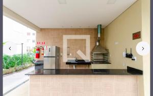 a large kitchen with a refrigerator and a stove at 1706 -Lindo apartamento próximo Tietê e Anhembi in São Paulo