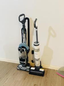 a group of golf clubs on a stand on the floor at A sweet home-Room D in Woodside