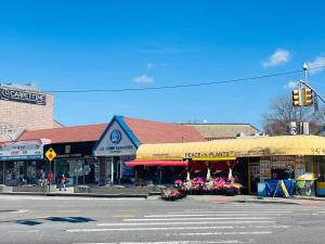 a street corner with a store with a yellow umbrella at A sweet home-Room D in Woodside