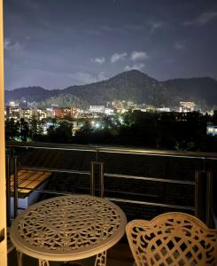 a table and chairs on a balcony with a view of a city at Aonang Mountain View A5 in Ao Nang Beach