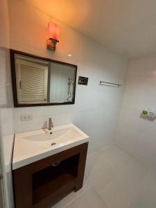 a bathroom with a sink and a mirror at Aonang Mountain View A5 in Ao Nang Beach