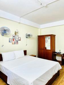 Postel nebo postele na pokoji v ubytování Oriio Hotel Cát Bà