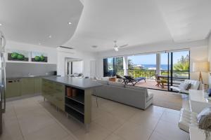 a kitchen and living room with a view of the ocean at 3 Hilltop Villas White Water Views from the Heart of Sunshine in Sunshine Beach