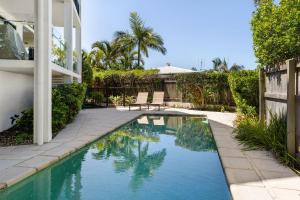 a swimming pool in the backyard of a house at 3 Hilltop Villas White Water Views from the Heart of Sunshine in Sunshine Beach
