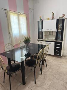 a dining room with a black table and chairs at YBVerde in Yerba Buena