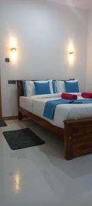 Ένα ή περισσότερα κρεβάτια σε δωμάτιο στο Mango Shadow Inn Ella