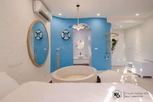 a bathroom with a tub and a blue wall at K6 Homestay in Hanoi +78 photos