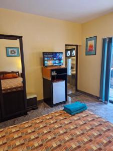 a bedroom with a bed and a tv and a television at Lonops Gay Paradise in Nong Prue