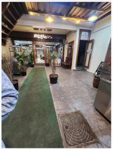 a hallway with a green carpet in a building at Heaven's Crest in Chennai