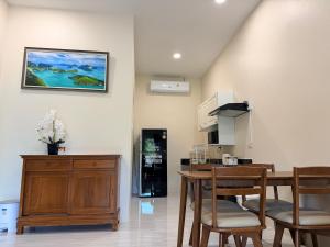 a kitchen and dining room with a table and chairs at Natural Samui Hotel in Bophut