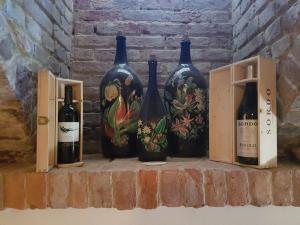 a group of wine bottles sitting on a shelf at La Crota B&B in Asti