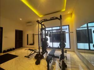 a gym with several exercise equipment in a room at Villa Velare 01 Dharmahusada Indah Galaxy Mall in Surabaya