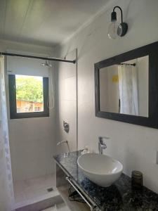 a bathroom with a sink and a mirror at Portal del Lago - Casa confortable cerca del lago - Hermoso atardecer in Federación