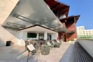 a patio with chairs and a table on a building at Moderno com piscina e perto da praia in Rio de Janeiro