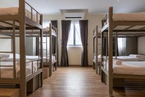 a room with four bunk beds with a window at DB Stay in Kuching