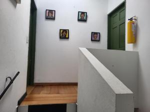 a hallway with pictures on the wall and a green door at Apartamento 201 completo Chía Norte in Chía +11 photos