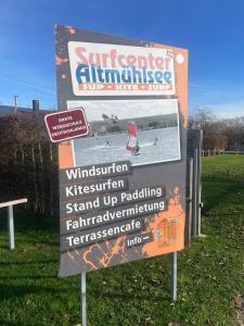 a sign for a windsurfer entrance at a beach at Ferienwohnung am Rosenhof in Lichtenau +2 photos