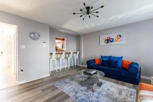 a living room with a blue couch and a table at BoardGame Bungalow in Atlantic City