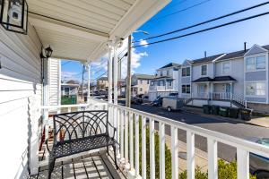 a porch of a house with a bench on it at BoardGame Bungalow in Atlantic City