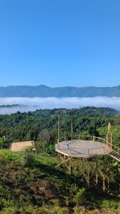 a wooden platform on top of a hill with a view at Toma Tungi Resort & Restaurant in Bāndarban