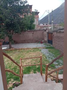 a stairway leading to a yard with a fence at CUSI Home in Urubamba