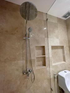 a shower with a glass door and a toilet at Medewi Surf Villa Luxury in Airsatang