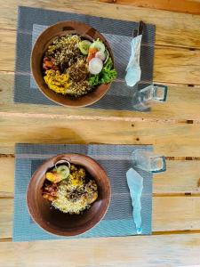 two plates of food on top of a table at Belihuloya Fattah Camping Resort in Belihul Oya