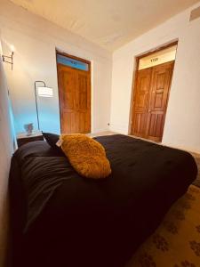 a bedroom with a large black bed with a window at Lartbook Mty in Monterrey