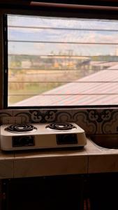 a stove sitting on a counter next to a window at Loftvibes San Juan - 5 in San Juan +19 photos