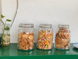 four glass jars filled with different types of food at Attic Hotel in George Town +23 photos