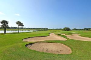 a golf course with palm trees and a sand bunker at GL1205: 1205 Greenslake in Kiawah Island