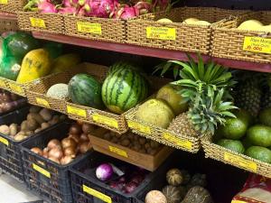 a display of fruits and vegetables in baskets in a store at HY Local Budget Hotel - 5 mins walk to Hoi An Ancient Town in Hoi An +50 photos