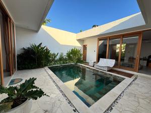 a swimming pool in the backyard of a house at Casa Gemellia Brand New 2BR in Umalas in Kerobokan +7 photos