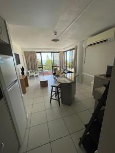 a view of a kitchen and a living room at Heart of Yeppoon - Ocean View Apartment in Yeppoon