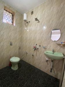 a bathroom with a toilet and a sink at Sunflake Stays in Agonda