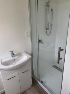 a bathroom with a sink and a shower at Newlands Bed and Breakfast in West Melton